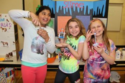 Three girls demonstrate their slime project