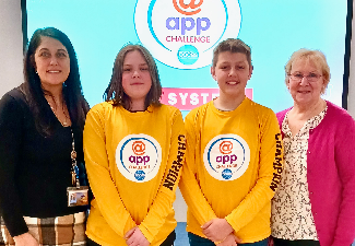 two boys and two adults with app challenge shirts