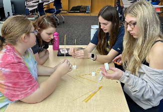 four girls work together on project