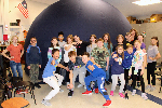 students pose in front of digidome