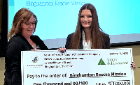 Cassandra Crisman presents check to charity