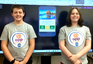 two male students in front of a big screen monitor