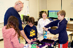 students browse through board games