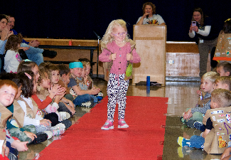 student walks fashion show runway