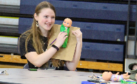 student holds doll