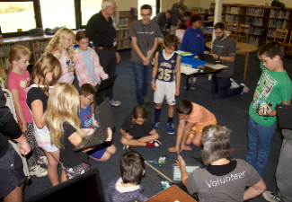 students watch robot tug of war