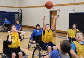 students play wheelchair basketball