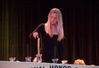 student lights national honor society candle