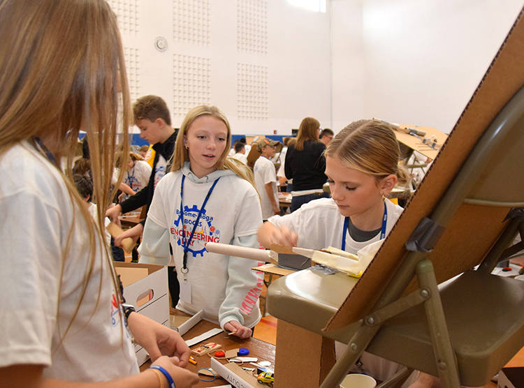 Middle School students tweak their Rube Goldberg machine during Engineering Day at B O C E S 