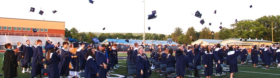 graduates toss caps at commencement
