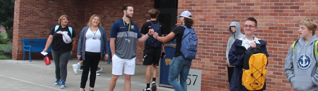 Student and teacher fist bump on first day of school