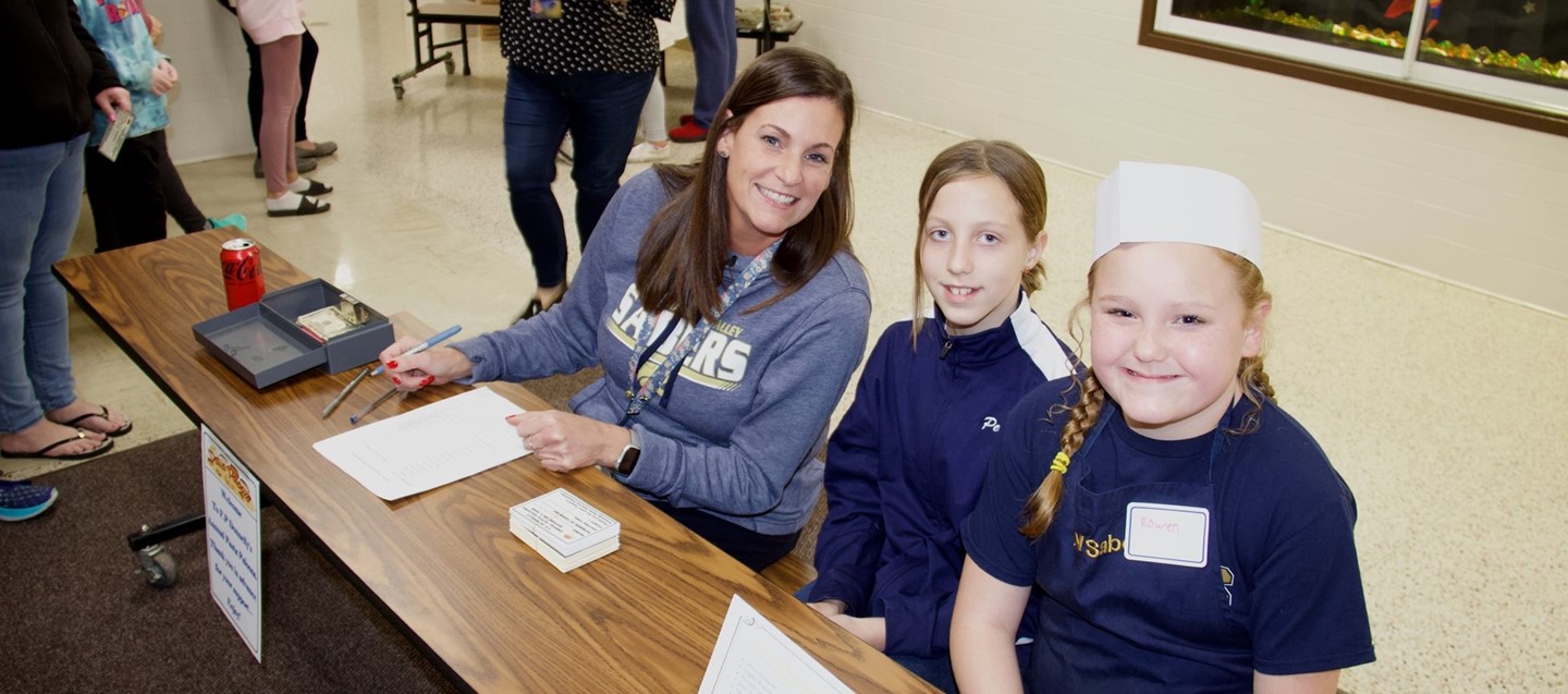 principal jill rich and two students