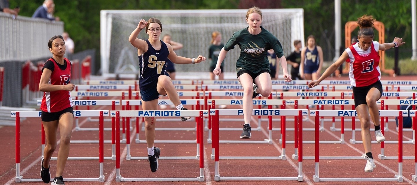 hurdles runners in track meet