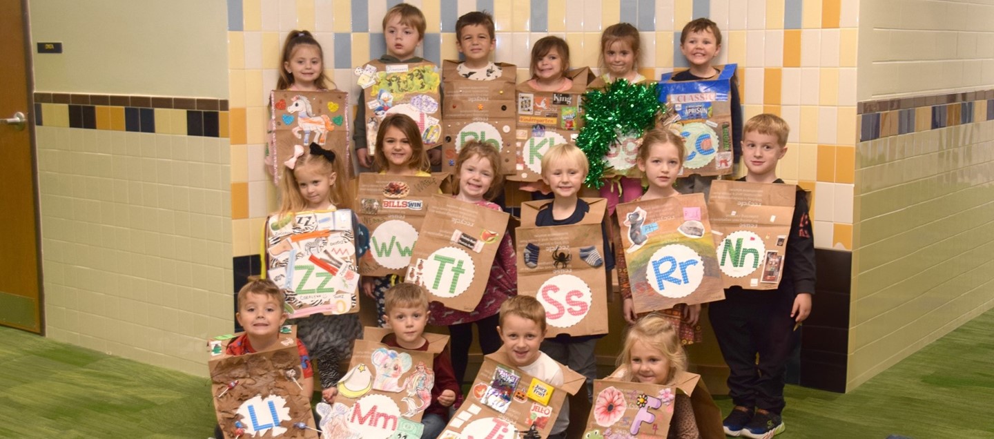 Universal Pre Kindergarten students wear paper bag vests highlighting the letter they represented during a literacy fashion show at Brookside Elementary