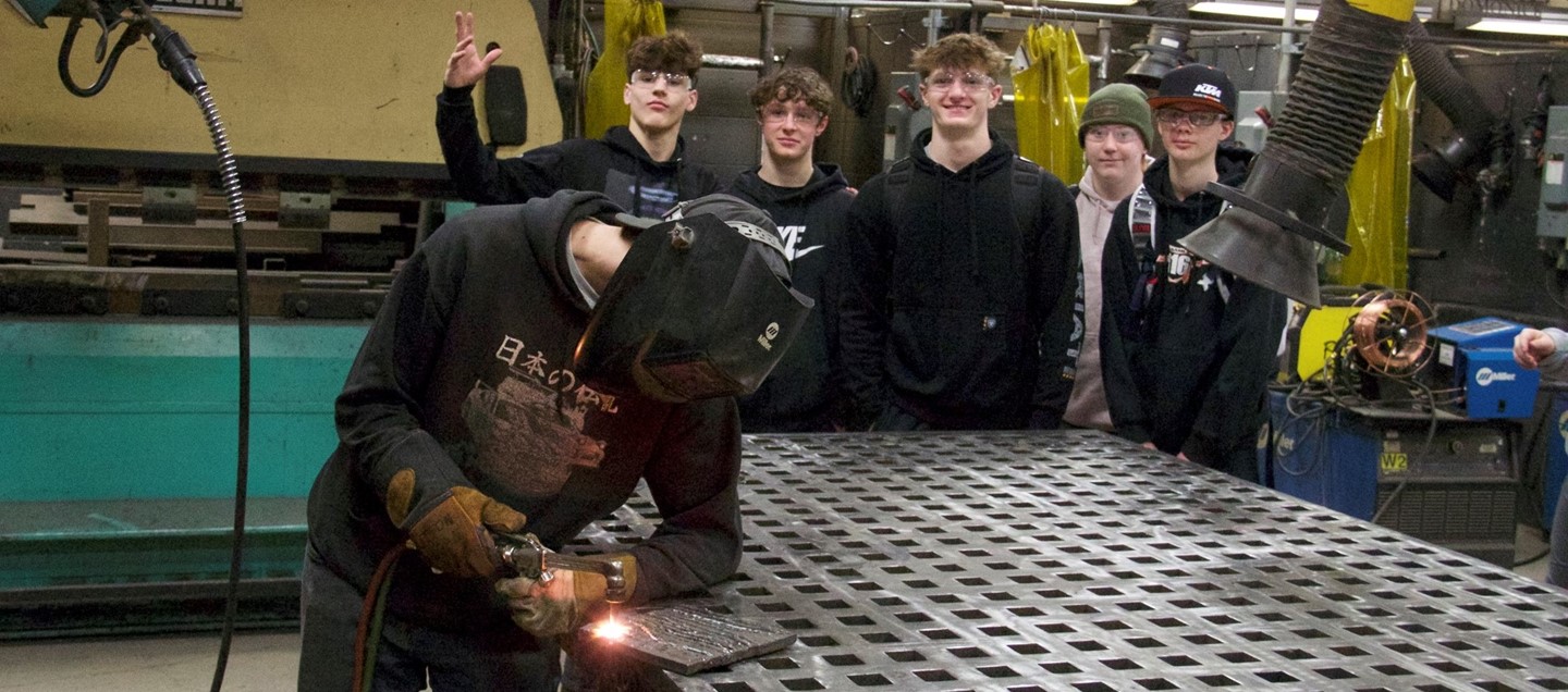 group of high school boys in welding class