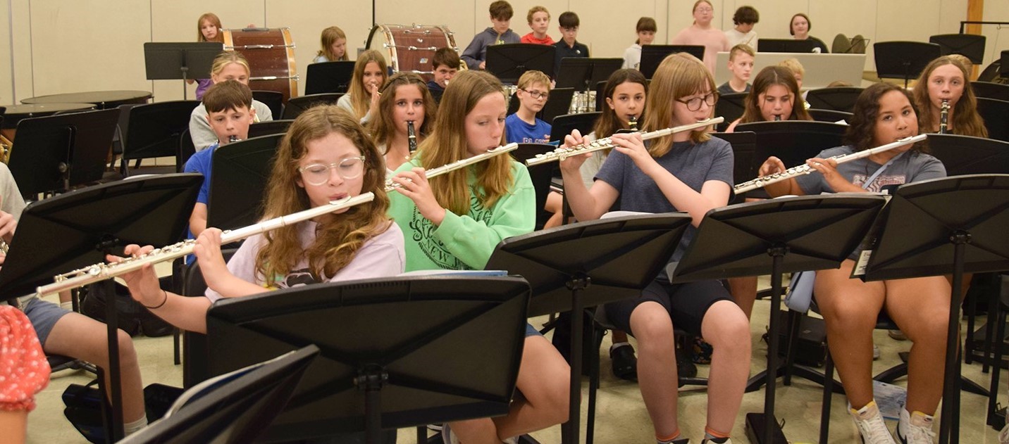 Middle School students practice their instruments in the band room.