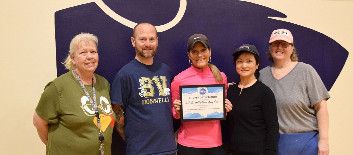 Food Service staff in Donnelly Elementary School holding their January Kitchen of the Month award.