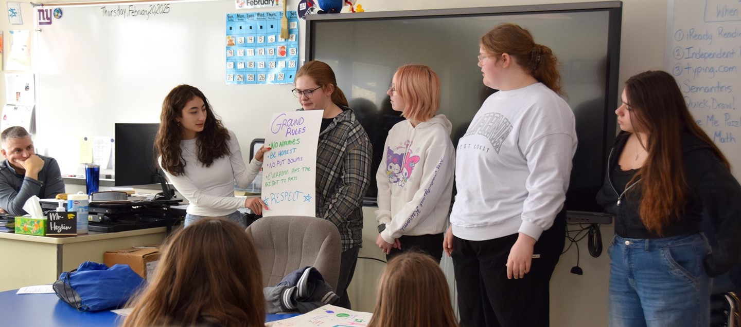 Five Susquehanna Valley High School students on the Peer Leaders team in front of a Brookside fifth grade classroom.