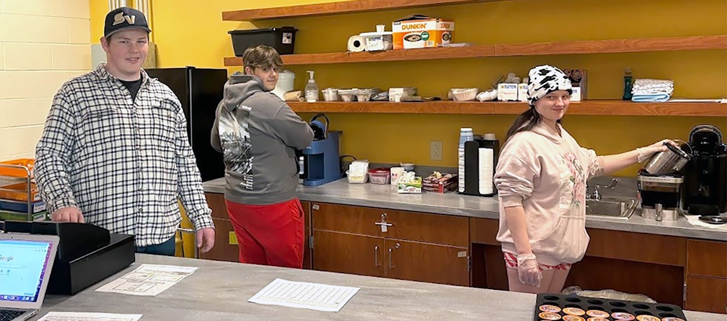 Three Susquehanna Valley High School students manage the morning dunk cafe in the new school library.