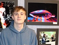 Asher Valentine next to his award winning photograph.